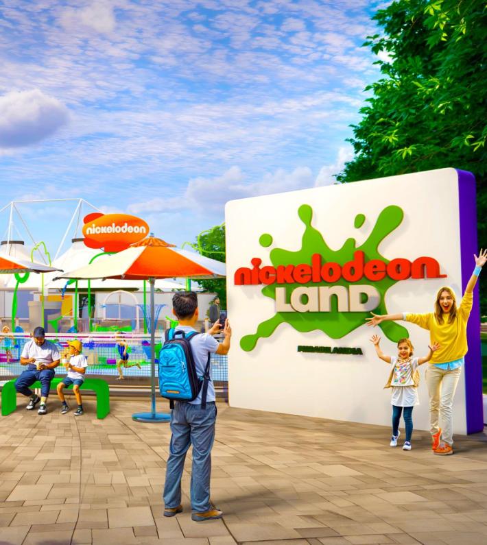 Parco divertimenti vivace con famiglie felici, sole splendente e atmosfera gioiosa.